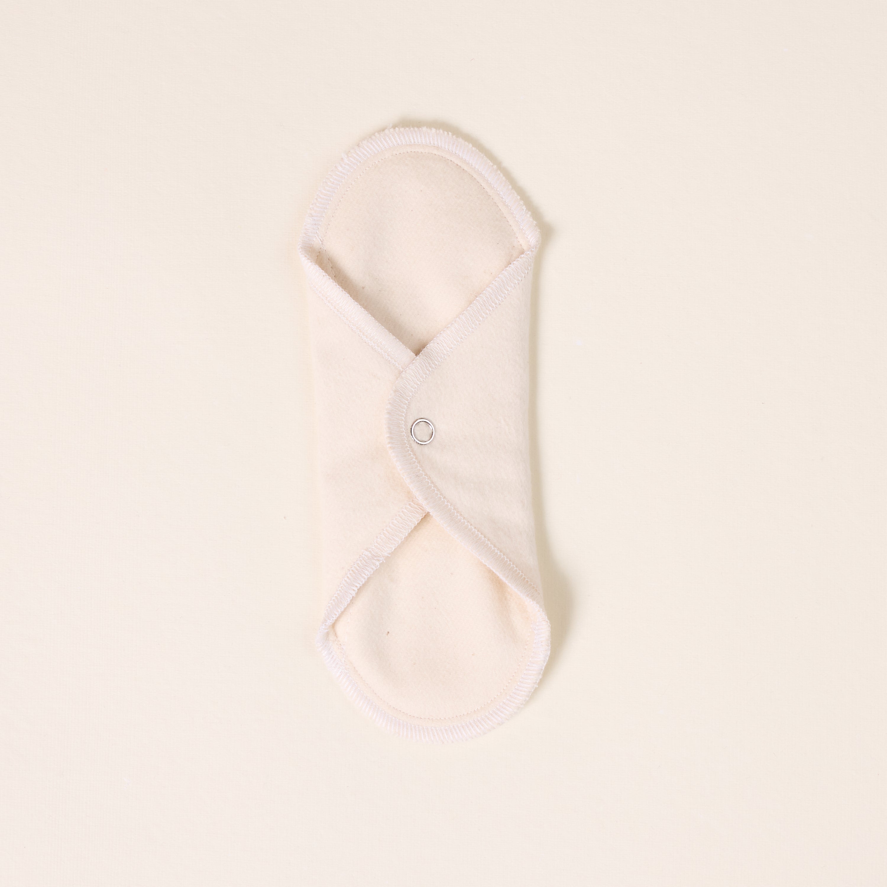 Folded white cloth on a light beige background