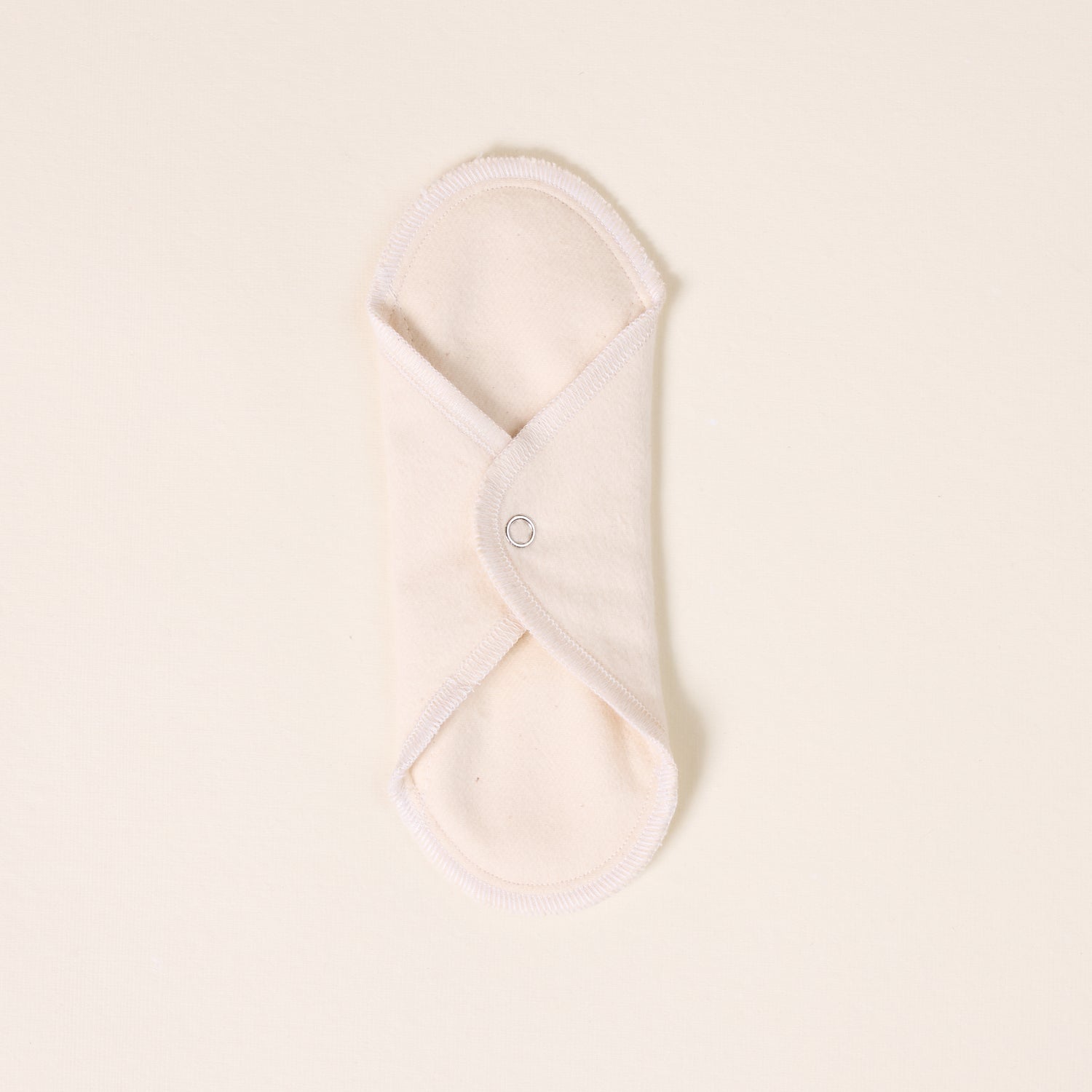 Folded white cloth on a light beige background