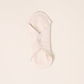 Folded white cloth on a light beige background