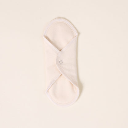 Folded white cloth on a light beige background