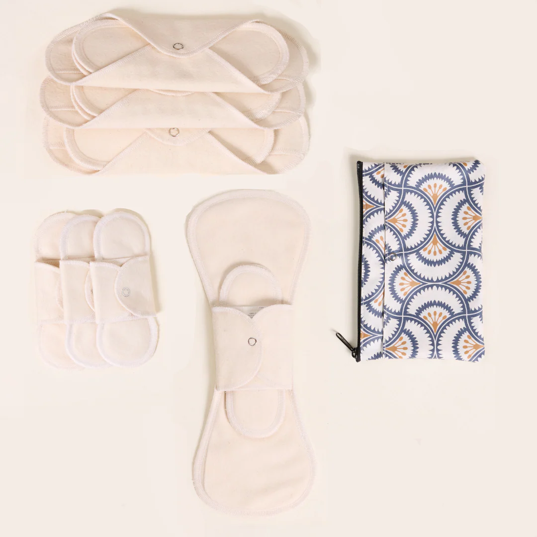 Cloth pad starter kit in organic white cotton with three pantyliners, three day pads, one night pad, and a zippered carry bag with floral pattern